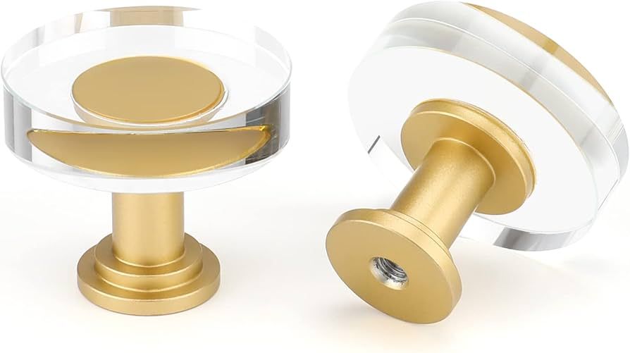 Zwei moderne Möbelknöpfe aus klarem Acryl mit goldener Metallbasis.